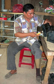 Seng Sophat repairs a radio